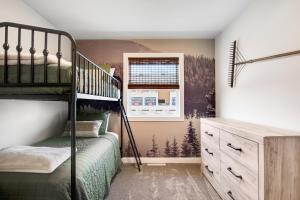 a childs bedroom with a bunk bed and a staircase at C&J's Park View in Baraboo