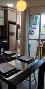 a kitchen with a table and a refrigerator at Beto Carrero Orion Club in Piçarras