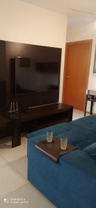 a bedroom with a tv and a bed with two cups on a tray at Beto Carrero Orion Club in Piçarras