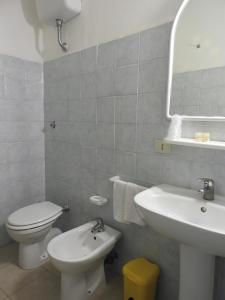 a bathroom with a white toilet and a sink at Appartamenti Lungomare Circeo in San Felice Circeo +7 photos