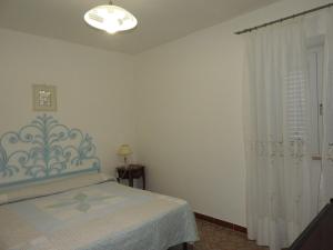 a bedroom with a bed and a window at Appartamenti Lungomare Circeo in San Felice Circeo