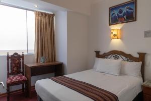 Postel nebo postele na pokoji v ubytování Hotel Rojas Inn