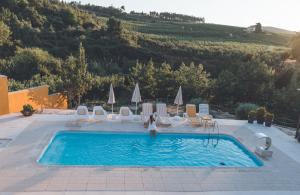 a woman is standing in a swimming pool at Casa da Mó - Douro in Armamar
