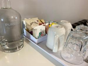 a bottle of water and glasses on a shelf at The Limes By Luigis Al Fresco in Maldon