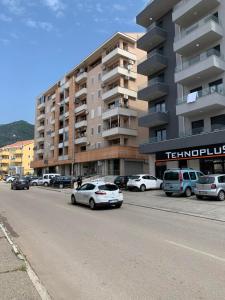 a parking lot with cars parked in front of a building at Apartment IDA in Budva