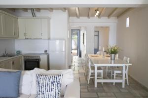 a kitchen and dining room with a table and a table and chairs at Beachfront 2br apartment - Free parking in Serifos Chora +16 photos
