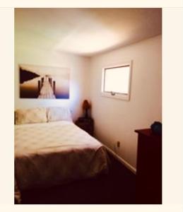 a bedroom with a bed and a window at Walking Distance To Beach And Shops in New Buffalo