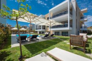 an external view of a house with a swimming pool at Sea Wind Luxury Apartments with Pool Kassandra Halkidikι in Nea Fokea