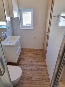 a bathroom with a toilet and a sink at Apartments SKY in Brela +19 photos