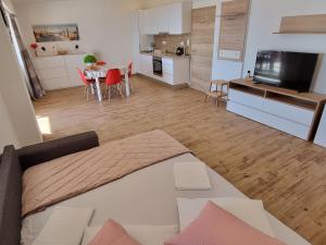 a living room and kitchen with a couch and a table at Apartments SKY in Brela