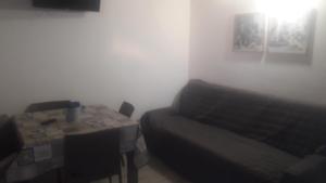 a room with a bed and a table and a bed and a table at Appartamento Vincenzina in Lampedusa