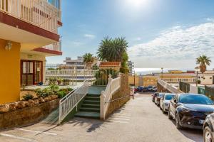 a stairway leading to a building with parked cars at Juan el fuerte in Torremolinos