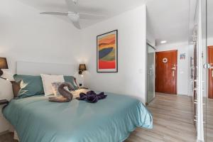 a bedroom with a bed with two swans on it at Juan el fuerte in Torremolinos +11 photos