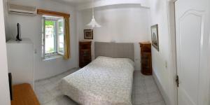 a bedroom with a bed in the corner of a room at Filoxenia Kontogiannis in Lazaráta