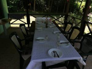 a table with a white table cloth on it with chairs at Vila Marina na obali Dunava in Neštin