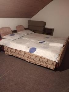 a large bed sitting in a room with at Vila Marina na obali Dunava in Neštin