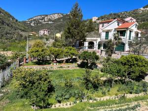 a house in the mountains with a garden at Rocca di Corno Guest House in Finale Ligure
