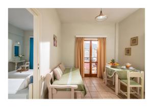 a room with a table and a dining room at Malia Semiramis by Estia in Malia