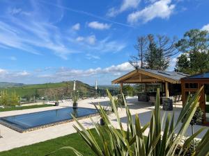 a swimming pool in a yard with a house at Forest View in Coed Ely