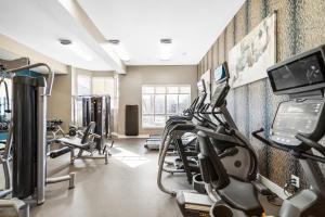 a gym with treadmills and ellipticals in a room at Kasa Downtown South Bend in South Bend