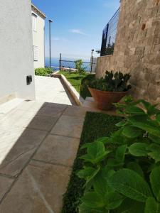 a walkway leading to a building with the ocean in the background at Royal Fort - Lovrijenac in Dubrovnik