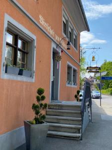 a building with stairs in front of a building at Garni-Hotel Mühletal in Stein am Rhein