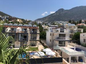 a group of buildings with mountains in the background at Stone House Aparts 2 plus 1 mit zwei Balkone und Poolview Kalkan No 10 in Kas