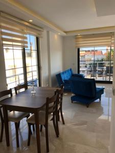 a living room with a dining room table and chairs at Stone House Aparts 2 plus 1 mit zwei Balkone und Poolview Kalkan No 10 in Kas