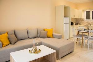 a living room with a couch and a table at Aurelia Seaside Apartment in Kavos
