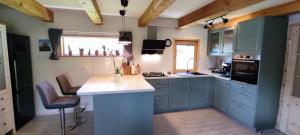 a kitchen with blue cabinets and a counter top at Wooden House Gabra in Podnart