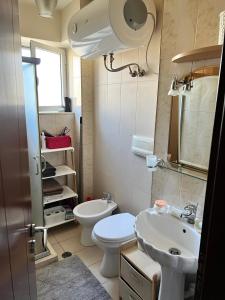 a small bathroom with a toilet and a sink at Midcentury modern 1 bedroom apartment in Tirana in Tirana