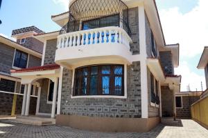 a house with a staircase on the side of it at SERENE 4 BEDROOMED HOME IDEAL FOR FAMILY HOLIDAY in Mombasa