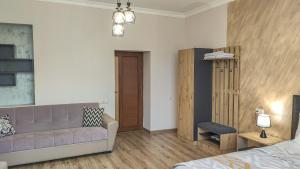 a living room with a couch and a bed at Harmonia Garden Hotel&Gastroyard in Garni