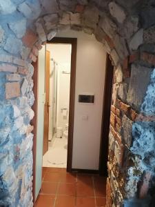 an entrance to a bathroom with a brick wall at Casa Sasso in Tavernola Bergamasca +8 photos