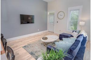a living room with a blue couch and a table at Incredible New 3BR2BA Near Downtown in San Antonio
