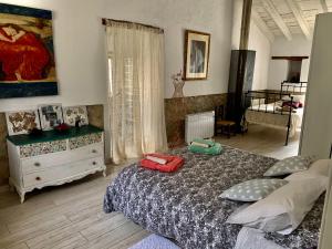 a bedroom with a bed and a dresser in it at Casa Tatisita Buhardilla in Segura de la Sierra