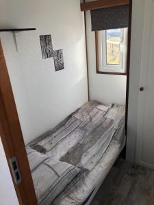 a bed sitting in a corner of a room at Chalet ZonZeeSion T12 with Bikes! in Buren