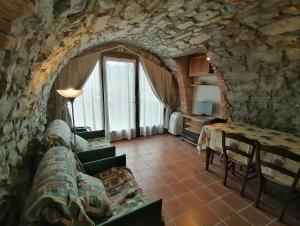 a living room with a couch and a table at Casa Sasso in Tavernola Bergamasca