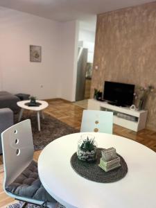 a white table and chairs in a living room at Centar NS in Novi Sad