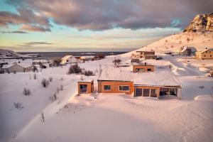 an aerial view of a house covered in snow at Lofoten panorama luxury home with sauna in Reine in Reine