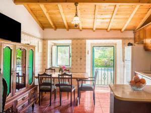 a kitchen with a dining room table and chairs at House is located on a corner in Montemor-o-Novo
