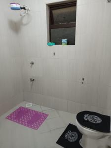 a bathroom with a purple toilet and a window at JJ homes 3 bedroom @Regal point apartments in Nairobi +86 photos