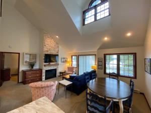 a living room with a table and a couch at Baileys Harbor Yacht Club Resort in Baileys Harbor