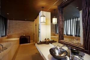 a bathroom with a sink, mirror, and bathtub at Centara Grand Mirage Beach Resort Pattaya - SHA Extra Plus in Pattaya North