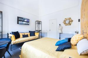 1 dormitorio con 2 camas y sofá en I Mori, en Catania