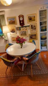 a table with a vase of flowers on it in a room at Honey house Lika in Gospić +67 photos