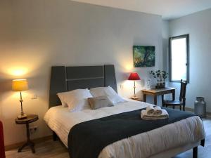 a bedroom with a large bed with two towels on it at Le Clos du Peintre in Sarlat-la-Canéda +29 photos