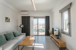 a living room with a couch and a table at Hermes&Dione in Argoulidhés