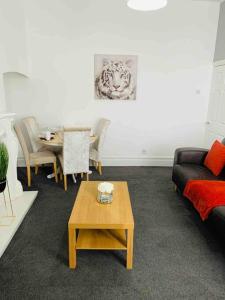 a living room with a couch and a table at Blessed Roker home with free parking. in Monkwearmouth