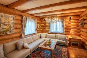 a living room with a couch and a table at Schilcherland Chalet Südsteiermark in Trahütten